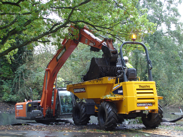 Excavating silt and detritus from dewatered lake.